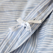 Subtle details such as soft corner stitching and delicate bow fasteners offer a sense of quiet luxury, combining effortless function with elegant finishing.