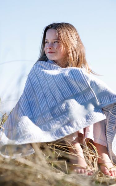 Moa_in_bath_towel_on_beach.jpg