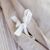 Subtle details such as soft corner stitching and delicate bow fasteners offer a sense of quiet luxury, combining effortless function with elegant finishing.Subtle details such as soft corner stitching and delicate bow fasteners offer a sense of quiet luxury, combining effortless function with elegant finishing.